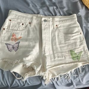 Levi’s white denim shorts with butterflies on them. This is a size 31